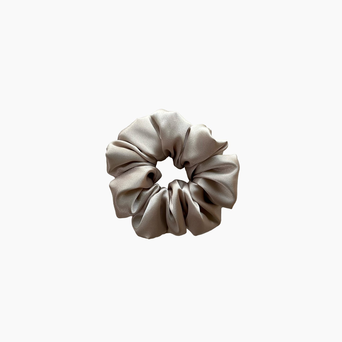 Beige satin scrunchie from Nude collection in medium size, displayed on a white background.
