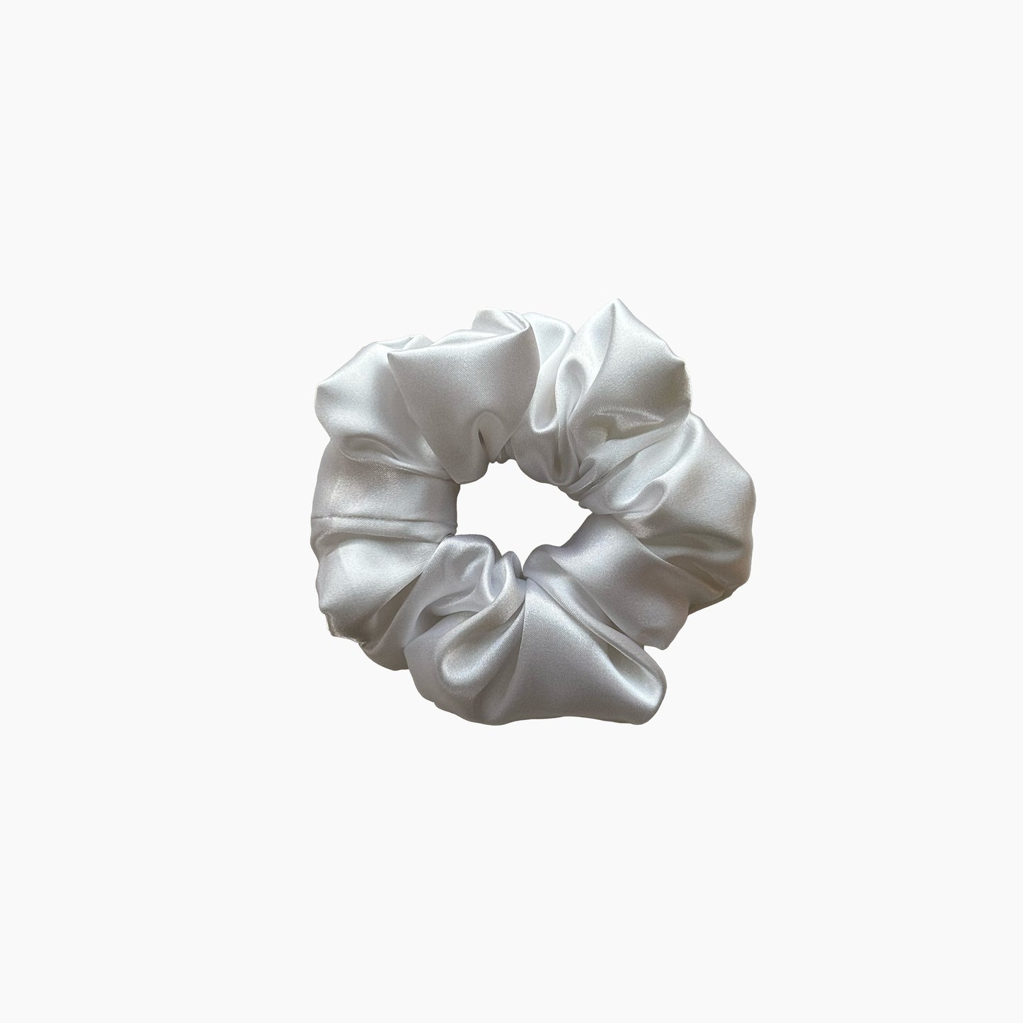 White satin scrunchie from Nude collection in medium size, displayed on a white background.