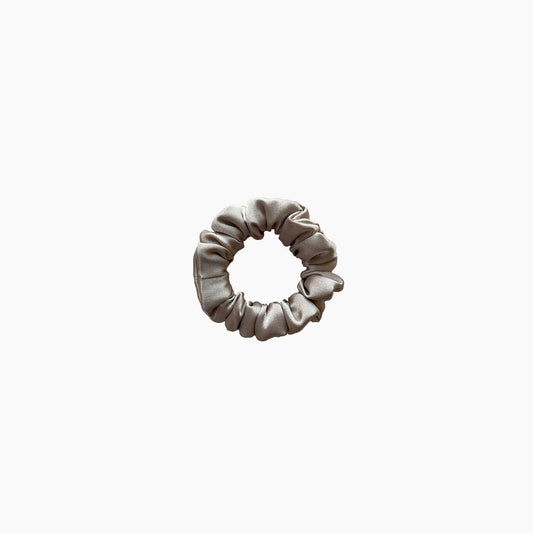 Beige satin scrunchie from Nude collection in mini size, displayed on a white background.