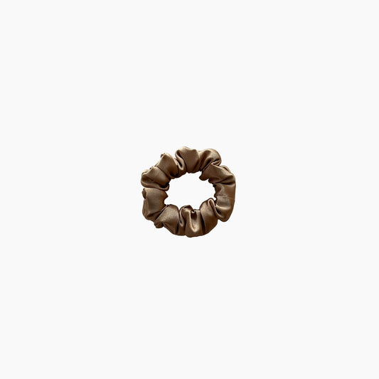 Gold satin scrunchie from Nude collection in mini size, displayed on a white background.