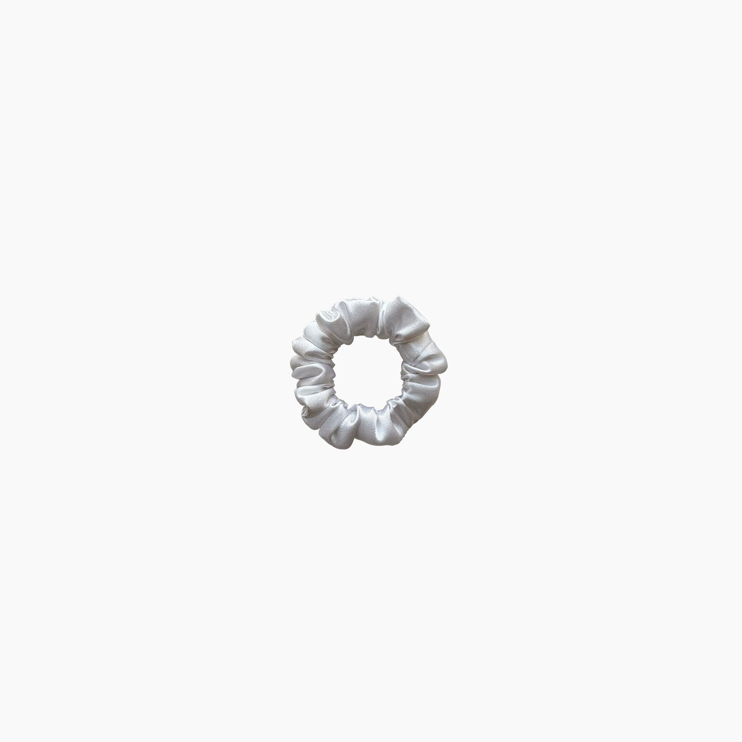 White satin scrunchie from Nude collection in mini size, displayed on a white background.