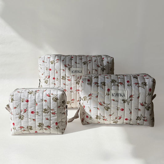 Front-facing view of Bell Pivoines quilted makeup bags collection in three sizes - mini, medium, and large on a soft white background.