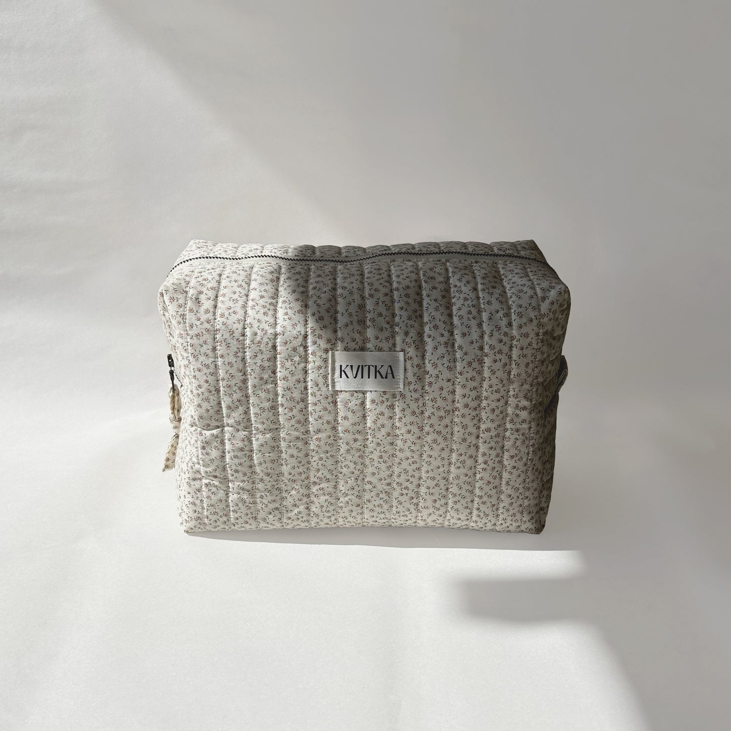 Large-size of quilted makeup bag from the Ditsy Blossom collection, displayed front-on with a visible KVITKA label on a soft white background.