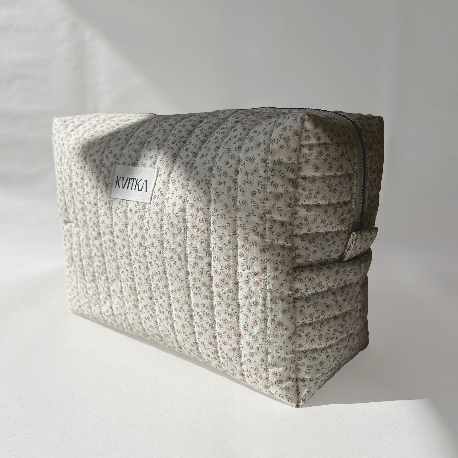 Large-size of quilted makeup bag from the Ditsy Blossom collection, angled to the right view on a soft white background.