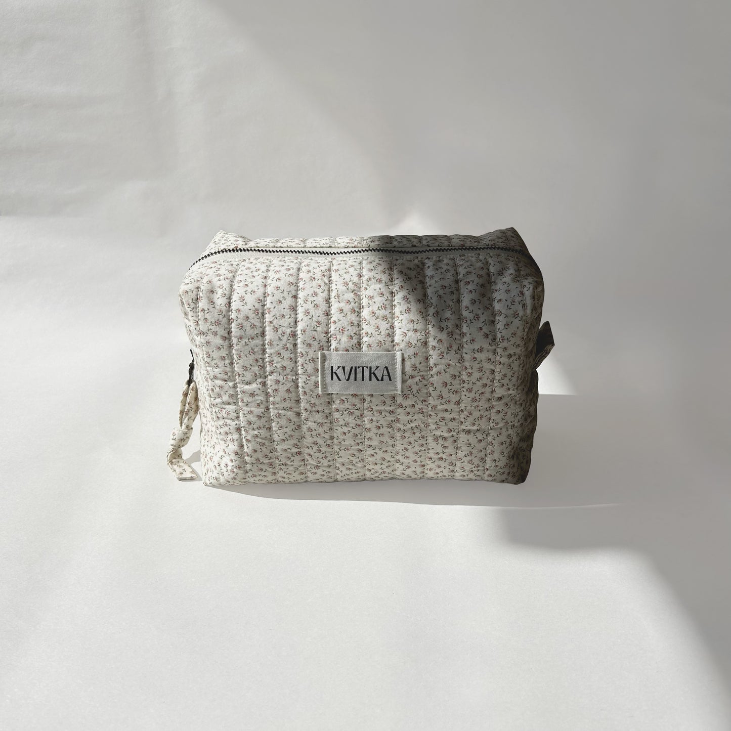 Medium-size of quilted makeup bag from the Ditsy Blossom collection, displayed front-on with a visible KVITKA label on a soft white background.