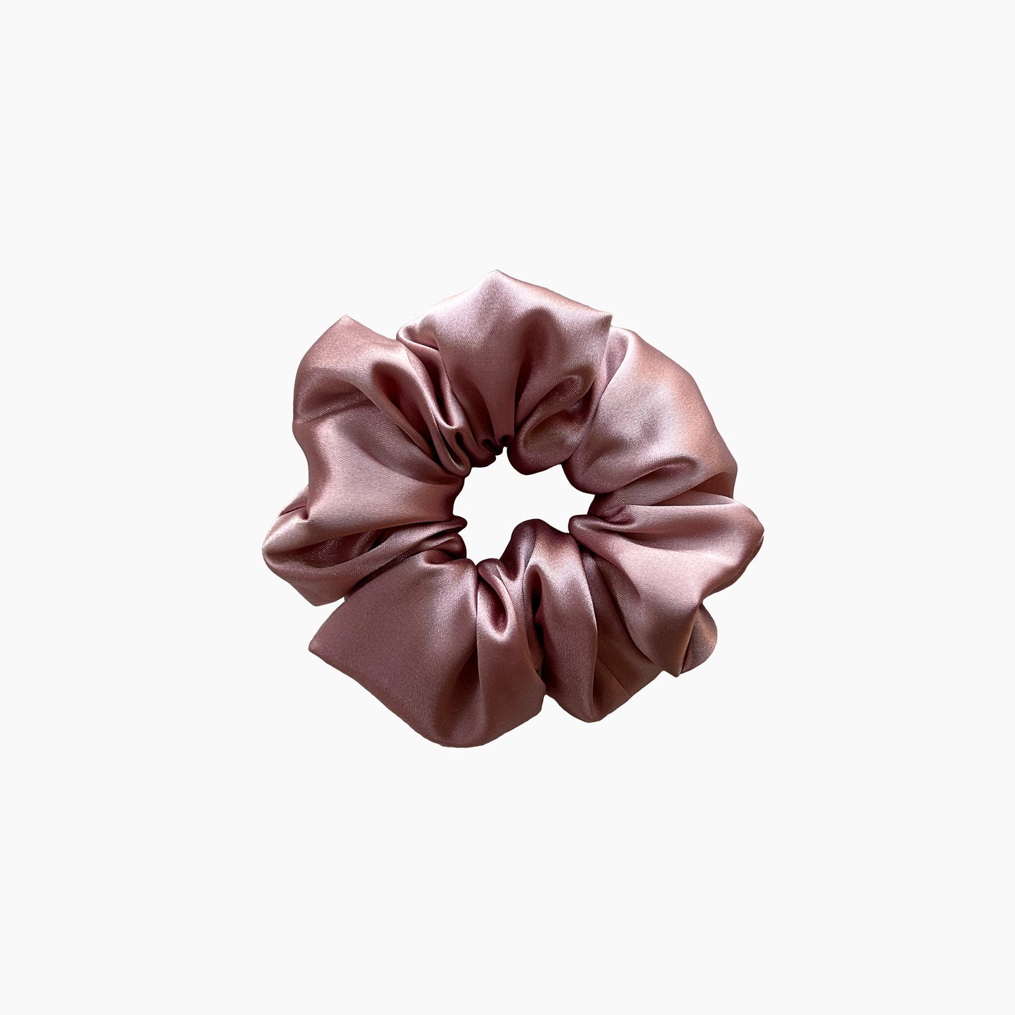 Pink satin scrunchie from Nude collection in medium size, displayed on a white background.