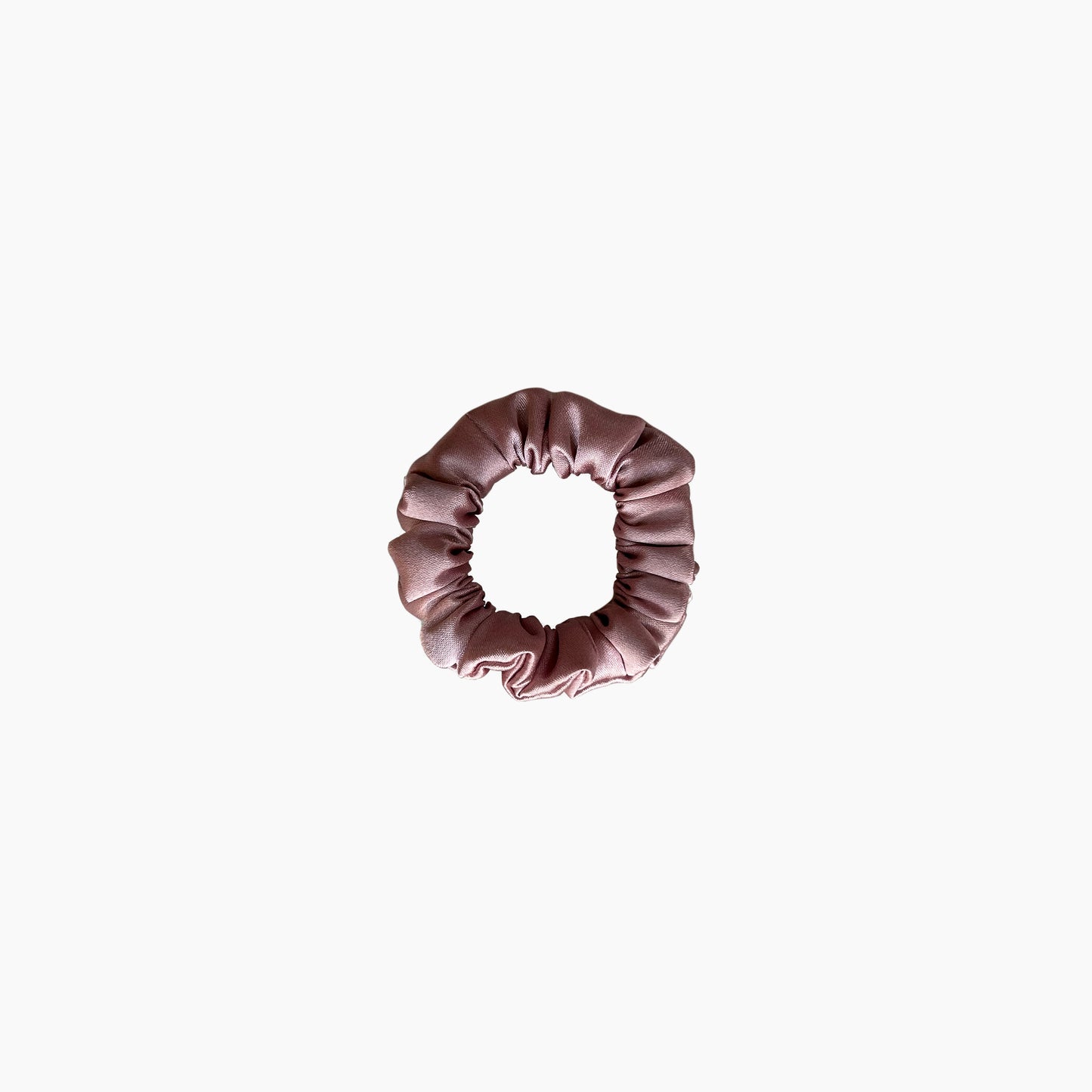 Pink satin scrunchie from Nude collection in mini size, displayed on a white background.