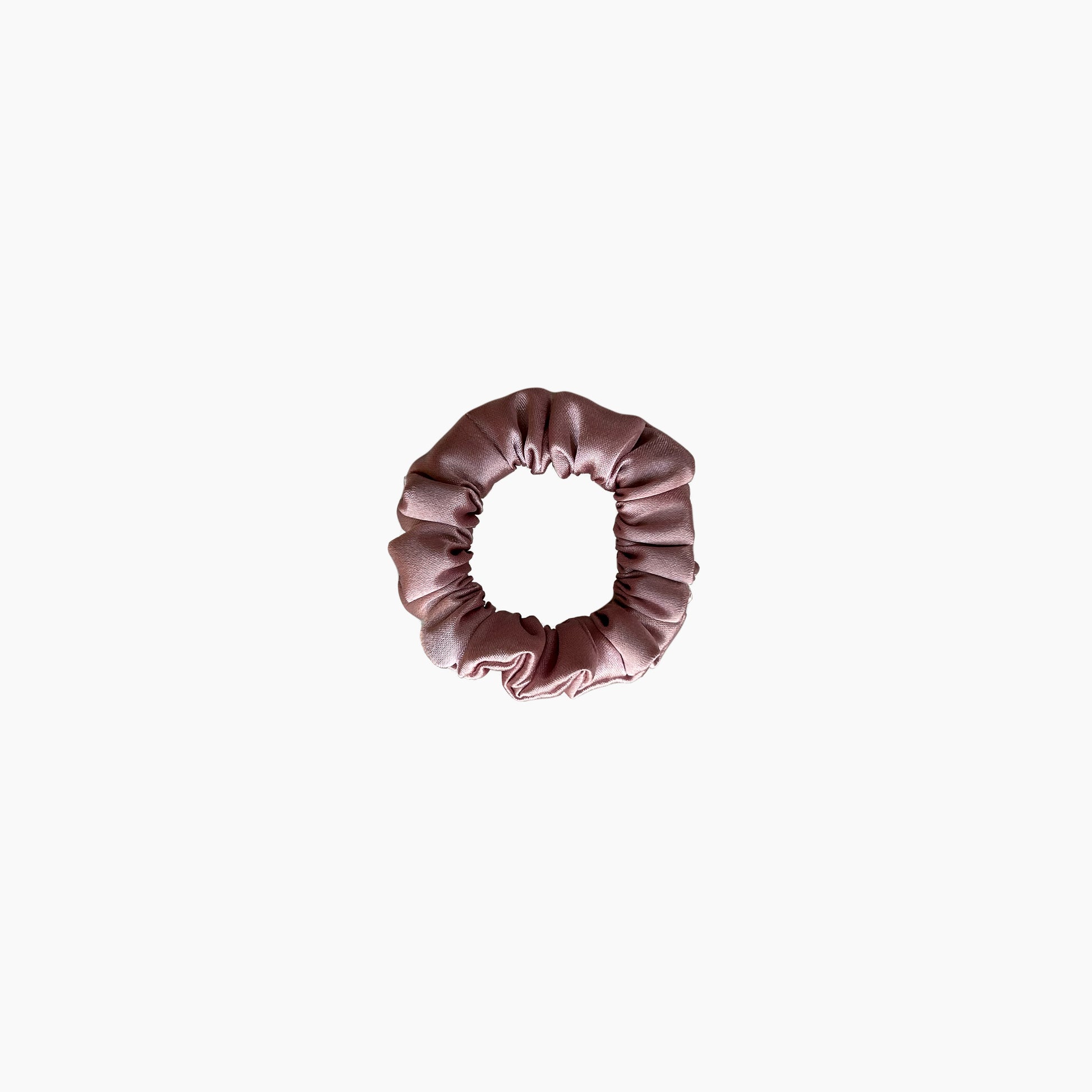 Pink satin scrunchie from Nude collection in mini size, displayed on a white background.